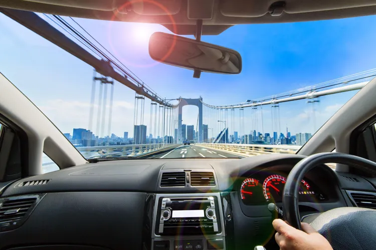 A view from the back seat of the chauffeur driving