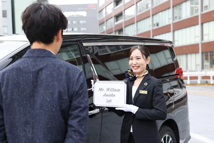 Travelers with luggage using a private chauffeur service in Japan